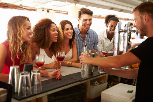 Bartender Serving Alcohol to Customers Bartender Serving Alcohol to Customers